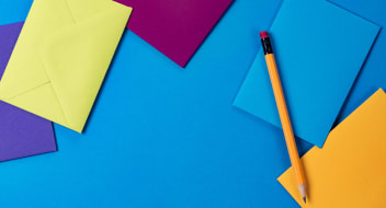 papers on blue table with pencil