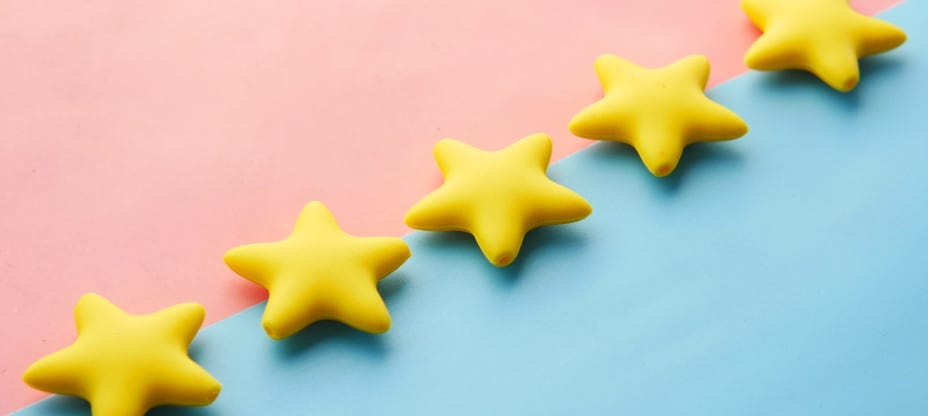 Five stars on pink-blue background