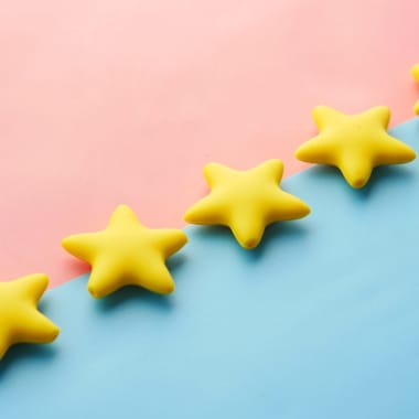 Five stars on pink-blue background